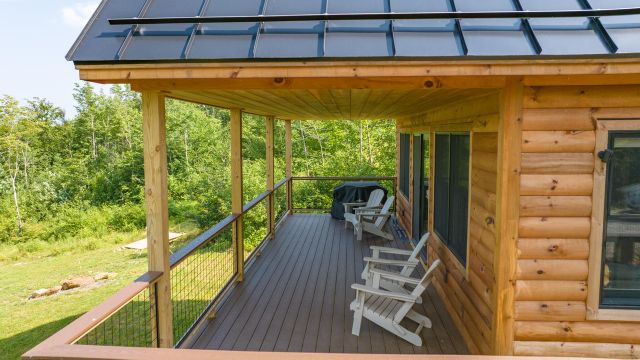 Lower deck at Runes Temple with Adirondack chairs and forest views